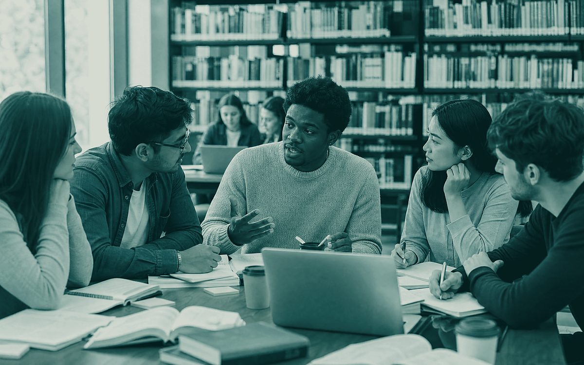 Researchers in discussion around a table in a library reading room